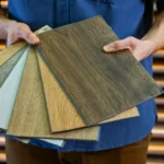 A man showcasing various types of vinyl flooring tiles, ideal for home interiors in Kerala. Learn how to choose the right vinyl flooring for your home.