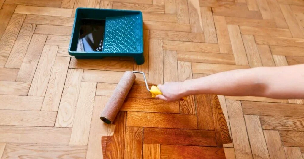 Applying finish to parquet and herringbone wooden flooring for maintenance in Kerala home