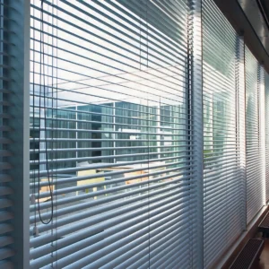 Stylish aluminium venetian blinds installed in a modern office setting in Kerala