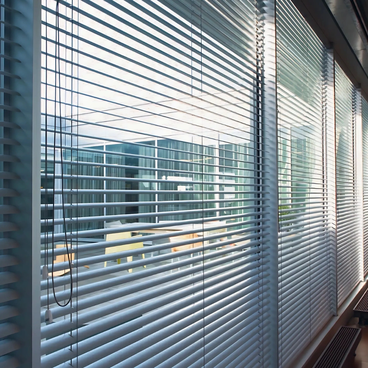 Stylish aluminium venetian blinds installed in a modern office setting in Kerala