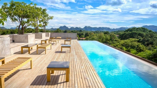 Learn how to choose moisture-resistant and anti-skid deck flooring for resort pool areas in Kerala’s monsoon climate.